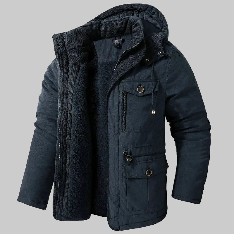 Dark blue winter jacket with a hood on a grey background